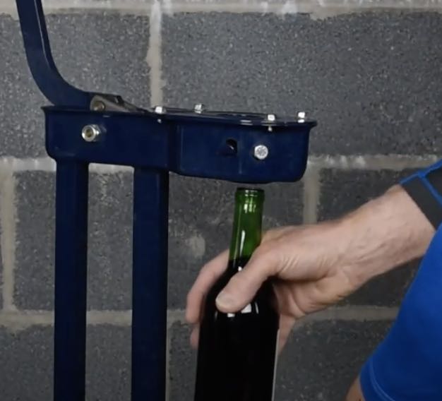 Placing wine bottle in corker